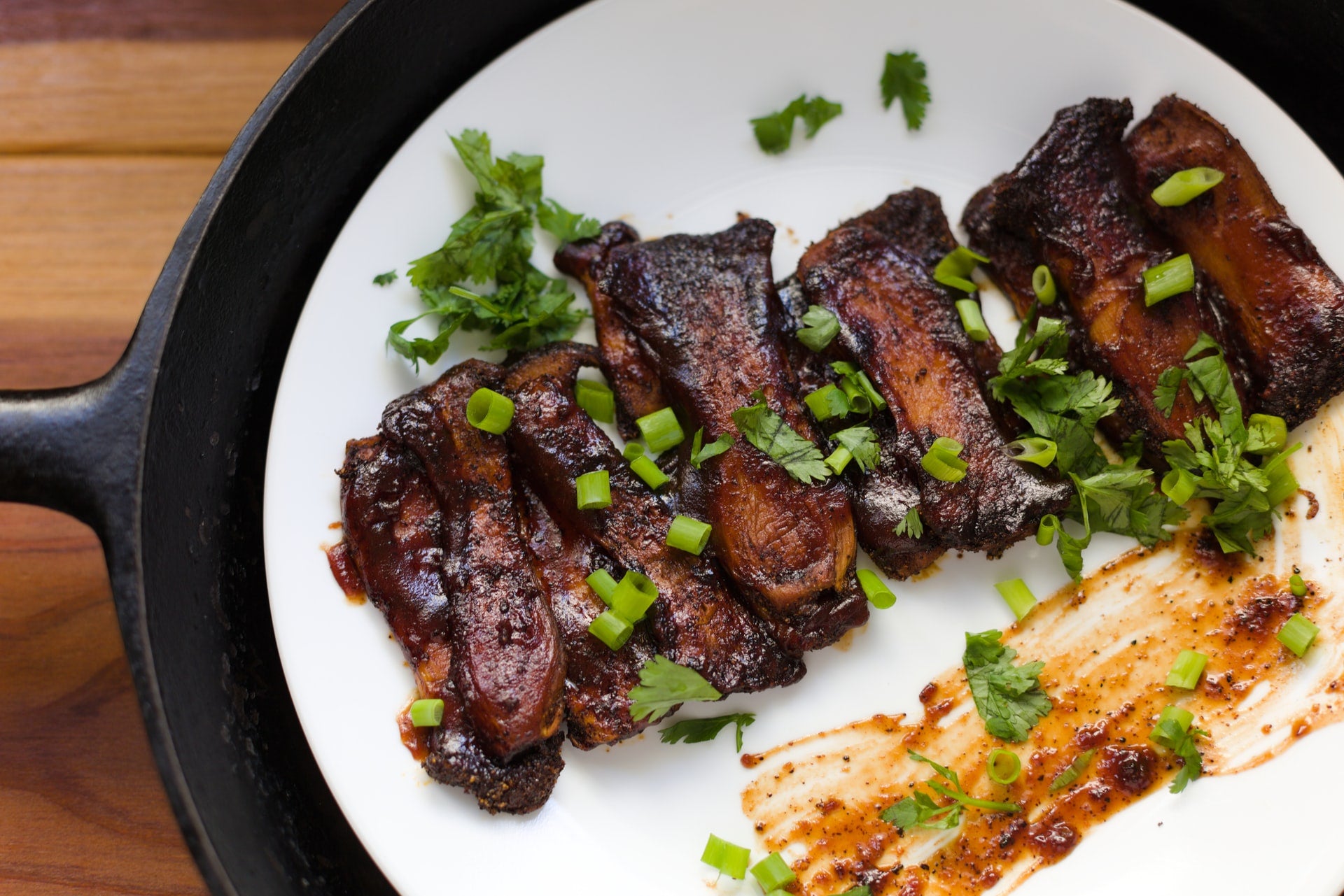 meat and greens on white plate